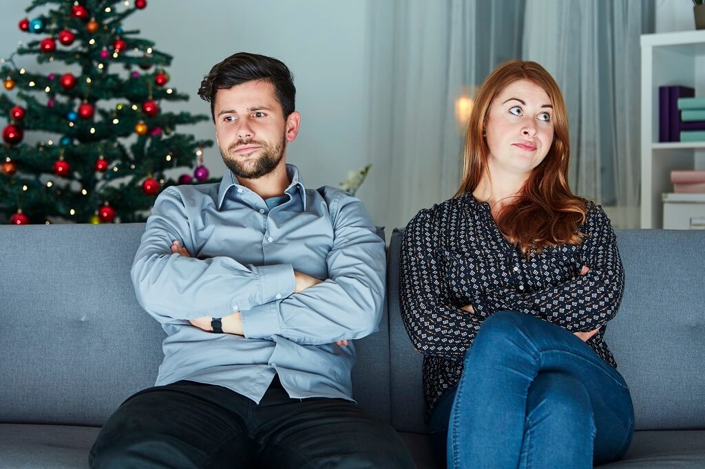 Unhappy couple at Christmas. It is the peak season for break ups and couples needing to find a family lawyer.