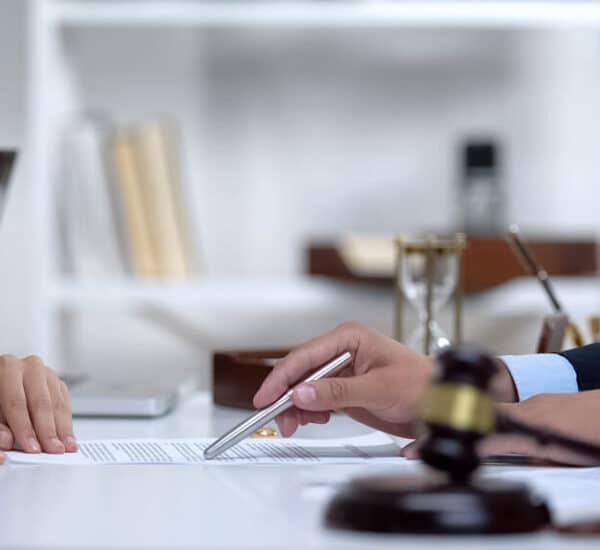 Lawyer showing person where to sign consent order