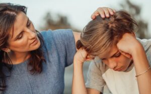 Parent comforting teenage boy child during separation and divorce