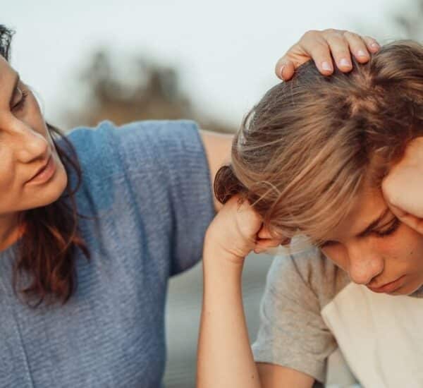 Parent comforting teenage boy child during separation and divorce