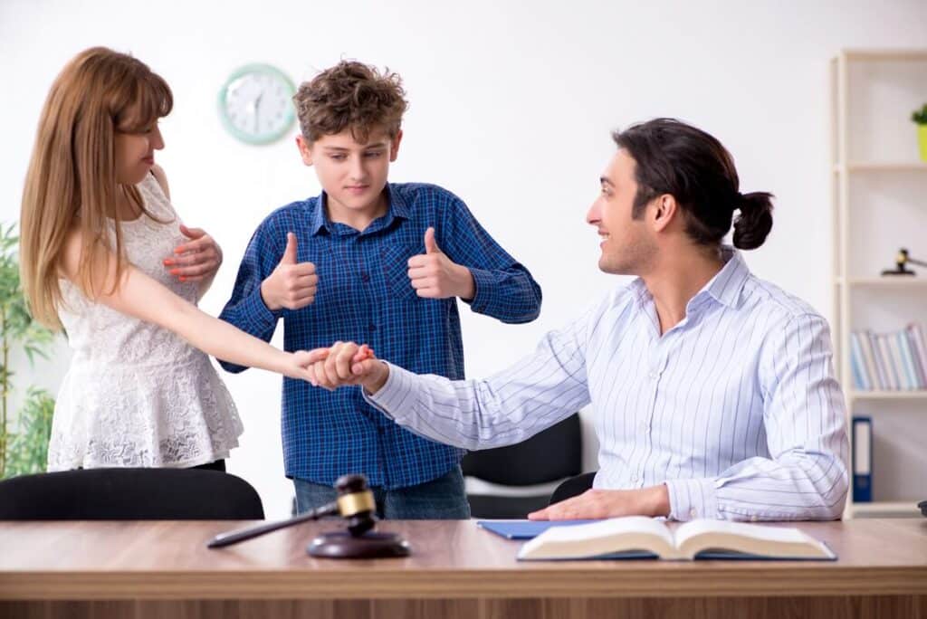 Happy child between parents successfully negotiating a Binding Child Support Agreement