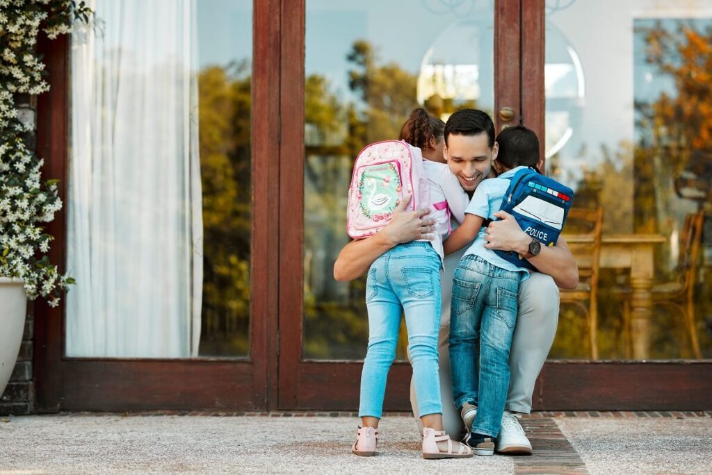 Father hugging children at the end of his allocated custody