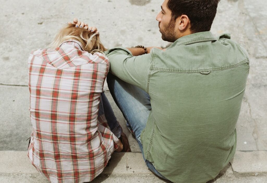 Woman sat next to narcissistic partner in controlling relationship